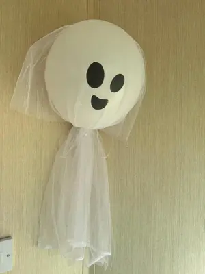 a white object with a face on a wall at Happy Place in West Mersea