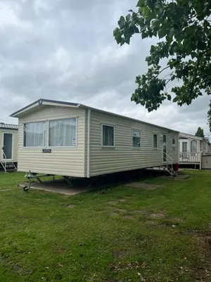 a mobile home is parked in a yard at Lovely place in Saint Osyth