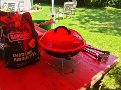 a red hat sitting on top of a table at The Potting Shed in Manuden