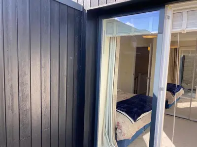 a room with a window with a bed in it at Homely & Warm Trumpington House w Parking, 5 mins drive to Bio Medical Campus, Addenbrooke's & Papworth hospitals in Cambridge