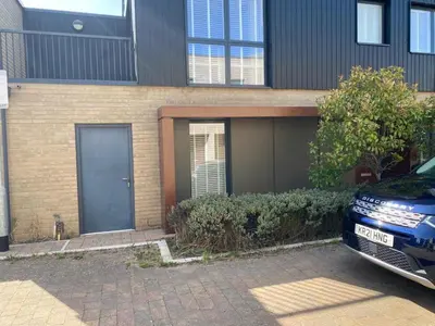 a house with a car parked in front of it at Homely & Warm Trumpington House w Parking, 5 mins drive to Bio Medical Campus, Addenbrooke's & Papworth hospitals in Cambridge