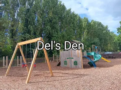 a playground with two play equipment with the words delis den at Del's den lakeside weeley bridge in Weeley