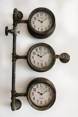 a group of clocks hanging on a wall at Modern and Cosy Flat For 4 in Cherry Hinton