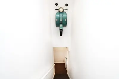 a hallway with a green fire hydrant on the wall at Modern and Cosy Flat For 4 in Cherry Hinton