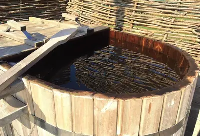 a wooden pool of water in a wooden tub at Lushna 8 Petite at Lee Wick Farm Cottages and Glamping in Clacton-on-Sea