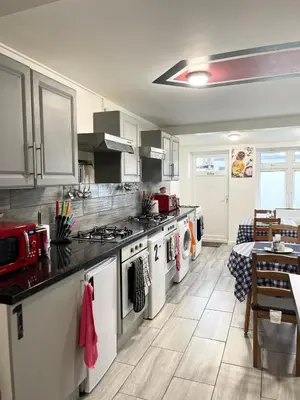 a kitchen with a stove and a counter top at Penn Gardens Flat 1 - 2 - 3 & 4 Apartments in Havering atte Bower