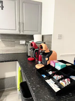a kitchen counter with a black tray filled with food at Penn Gardens Flat 1 - 2 - 3 & 4 Apartments in Havering atte Bower