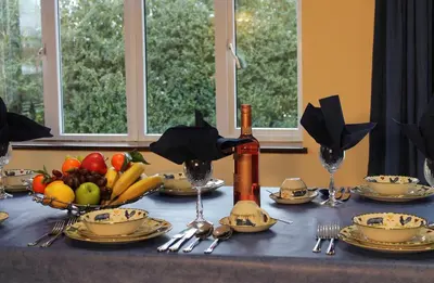 a table with a bowl of fruit on it at Colston Hall Cottages in Framlingham