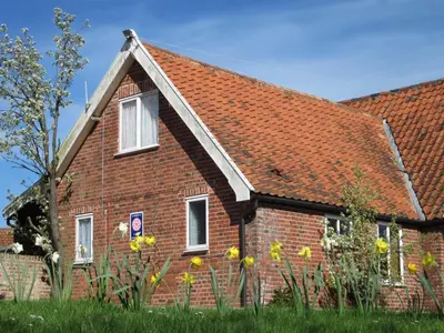 a red brick house with a red roof at Colston Hall Cottages in Framlingham