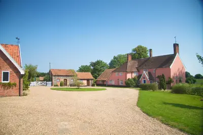 a group of houses with a gravel driveway at Colston Hall Cottages in Framlingham