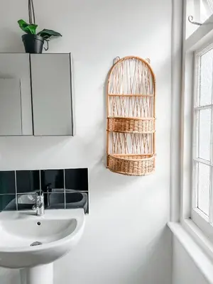 a bathroom with a sink and a mirror and a basket at Dog and Whistle Pub in Hertford