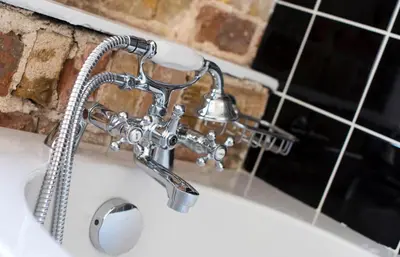 a bathroom sink with a faucet at Dog and Whistle Pub in Hertford