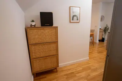 a room with a dresser with a television on top at Boho Style - KING BED, Central, Super FAST Wi-Fi in Cambridge