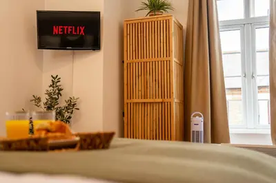 a table with a plate of food in a room at Boho Style - KING BED, Central, Super FAST Wi-Fi in Cambridge
