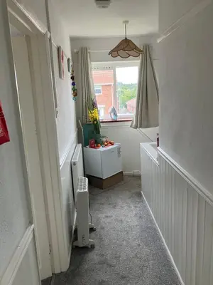 a small bathroom with a heater and a window at Comfortable rooms upstairs at number 8 in Moulton