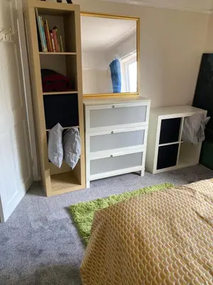 a bedroom with a white dresser and a mirror at Comfortable rooms upstairs at number 8 in Moulton