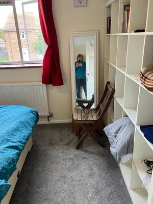 a person taking a picture in a mirror in a bedroom at Comfortable rooms upstairs at number 8 in Moulton