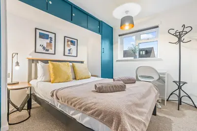 a bedroom with a large bed and a window at Comfortable 4-BDR House, Sleeps 7, WIFI, Secure Parking in Cambridge