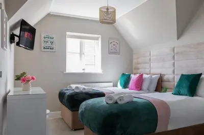 a bedroom with two beds with towels on them at Weekly & Monthly Rates! Stunning Home By Stansted Airport in Bishops Stortford