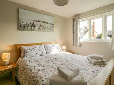 a bedroom with a bed and a window at Bramley Cottage in Clacton-on-Sea