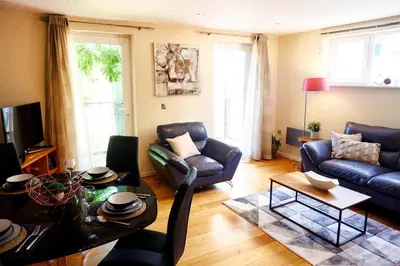 a living room with a couch and a table at Stunning Apartment close to Cambridge Station with FREE Parking! in Cambridge