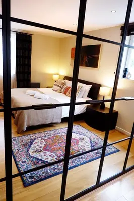 a bedroom with a bunk bed and a large rug at Stunning Apartment close to Cambridge Station with FREE Parking! in Cambridge