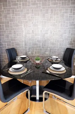 a black table with chairs and plates and wine glasses at Stunning Apartment close to Cambridge Station with FREE Parking! in Cambridge