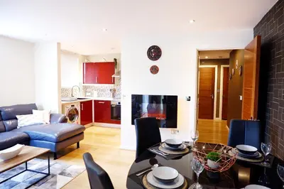 a living room with a couch and a dining room at Stunning Apartment close to Cambridge Station with FREE Parking! in Cambridge