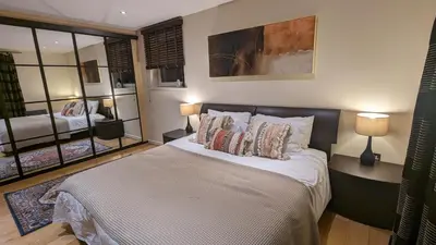 a bedroom with a bed with pillows and two lamps at Stunning Apartment close to Cambridge Station with FREE Parking! in Cambridge