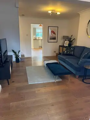 a living room with a couch and a table at Chic 2 bedroom cottage in Willingham