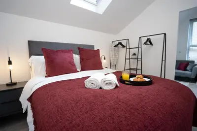 a bedroom with a bed with a tray of food on it at The Den - KING BED, 5 min walk to City Centre in Cambridge