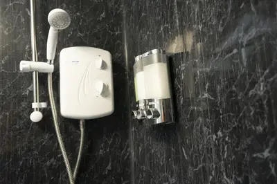 a hair dryer and a blow dryer on a wall at The Den - KING BED, 5 min walk to City Centre in Cambridge