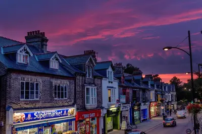 a row of houses on a street at sunset at The Den - KING BED, 5 min walk to City Centre in Cambridge