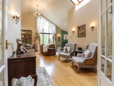 a living room with chairs and a table at 256 London Road in Colchester