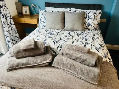 a bed with towels on it in a bedroom at The Annex in Southend-on-Sea