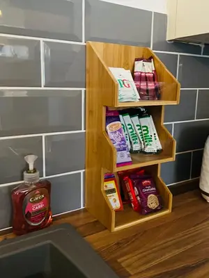 a wooden shelf next to a sink in a bathroom at The Annex in Southend-on-Sea