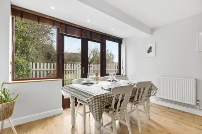 a dining room with a table and chairs at Entire 2 bed coach house in peaceful Norfolk village in Pulham