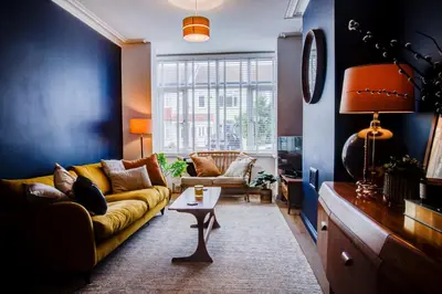 a living room with a couch and a table at Cosy house on the seafront - Pass the Keys in Southend-on-Sea
