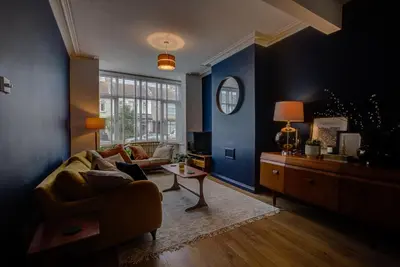 a living room with a couch and a table at Cosy house on the seafront - Pass the Keys in Southend-on-Sea