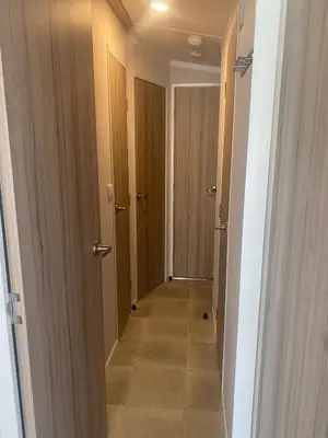 a hallway with two doors and a tile floor at Modern Family Caravan with WiFi at Valley Farm, Clacton-on-Sea in Great Clacton
