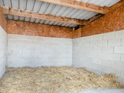 a horse stable with hay inside of it at Chestnut Lodge in Old Buckenham