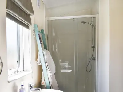a bathroom with a shower with a sink and a shower at Lodge 38 in Stowmarket