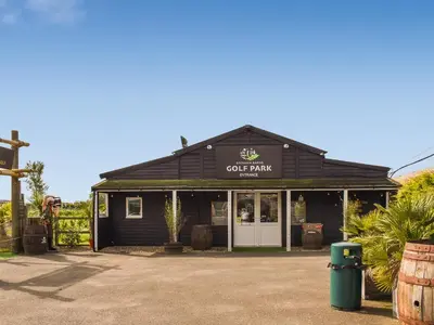 a black building with a sign that reads coffee farm at Lodge 38 in Stowmarket