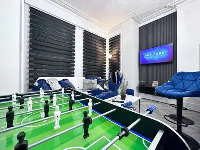 a living room with a game of bowling at Swanky Seaside Sanctuary w foozeball - Southend in Southend-on-Sea