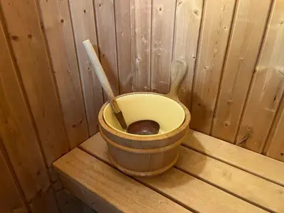 a wooden bucket with two wooden spoons in it at Sorrento Hotel & Restaurant in Cambridge