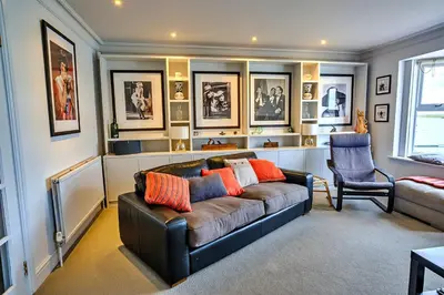 a living room with a couch and a chair at Finest Retreats - Kings Wharf - Luxury Riverside Home in Burnham on Crouch