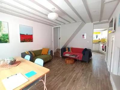 a living room with a couch and a table at Kingfisher Cottage - Woodbridge in Woodbridge
