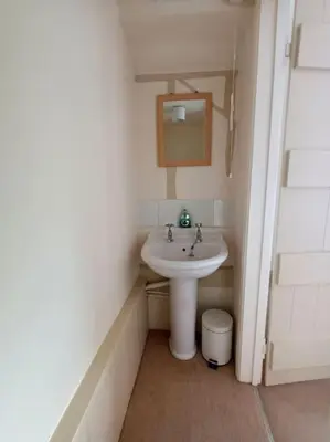 a small bathroom with a sink and a mirror at Period Cottage near Suffolk Coast and Forest in Tunstall