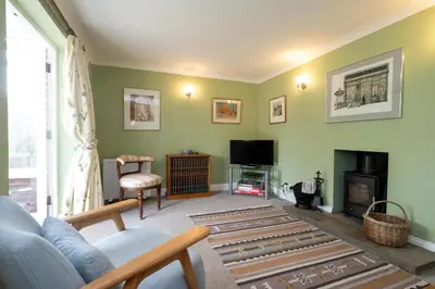 a living room with a couch and a tv at 8 Saxonfields in Snape