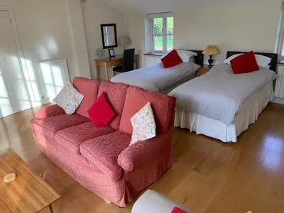 a living room with two beds and a couch at Field Cottage Bed and Breakfast in East Harling
